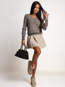Sweter merino OH HONEY PURE w kolorze taupe na modelce – cała stylizacja z jasną spódniczką i botkami.